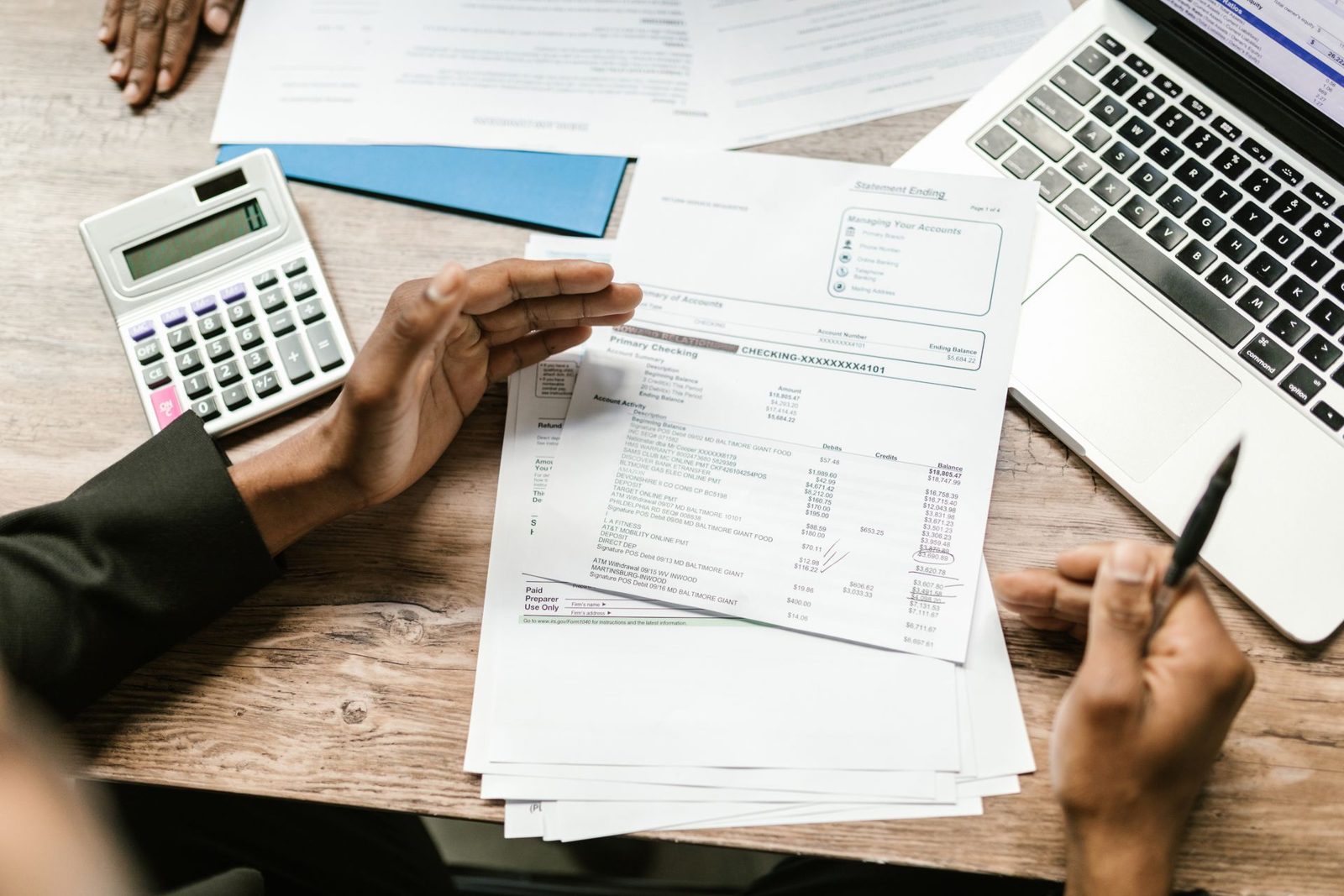 ALWESAM accountants reviewing financial documents