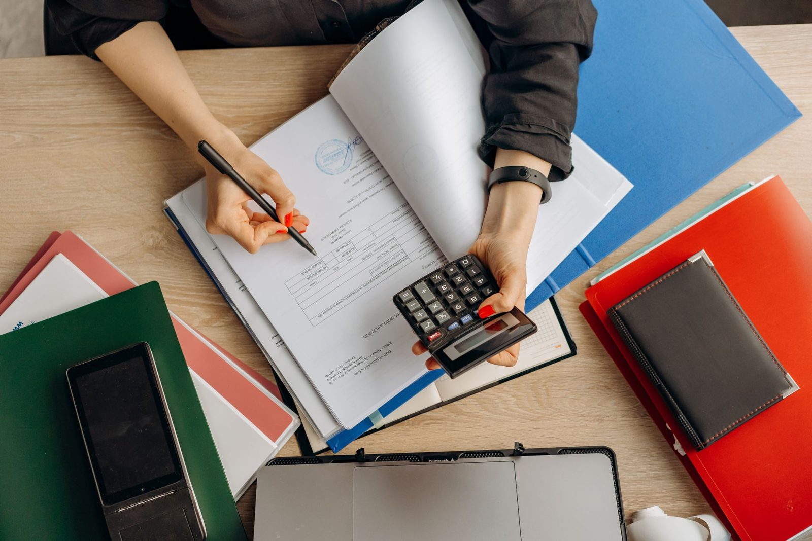 Accountant reviewing documents with a calculator